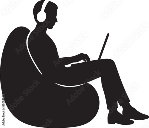 Person wearing headphones using a laptop while sitting in a beanbag chair silhouette