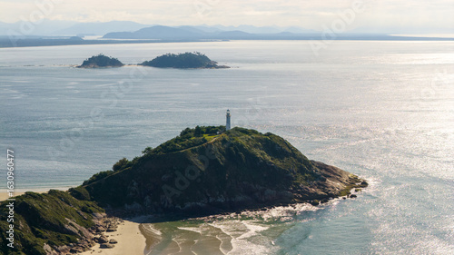 Canvastavla Drone view of Farol das Conchas lighthouse on Ilha do Mel, Paraná, Brazil, with ocean and distant islands