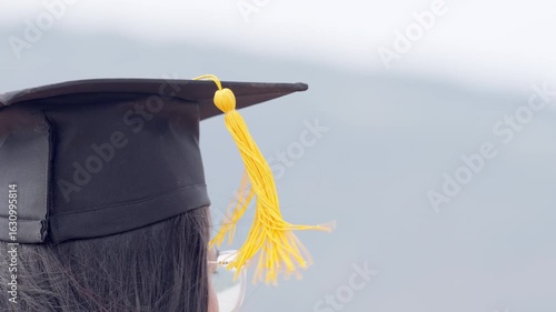Wallpaper Mural A woman wearing a black cap and gown with a yellow tassel. She is wearing glasses Torontodigital.ca