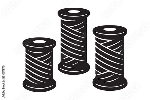 Three spools of black thread arranged in a cluster isolated on white background