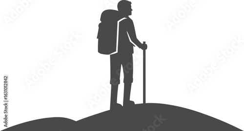 Silhouette of a hiker with a backpack and trekking pole standing on a hill