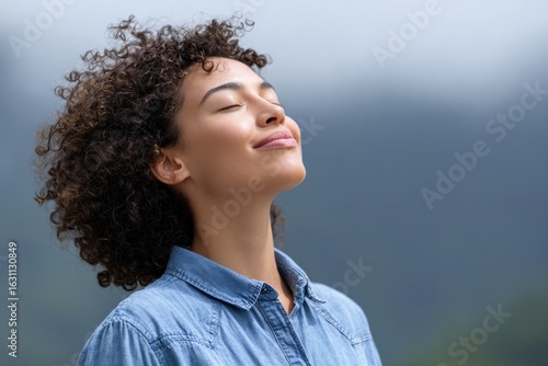 x-default Woman enjoying fresh air, breathing deeply, curly hair, denim shirt