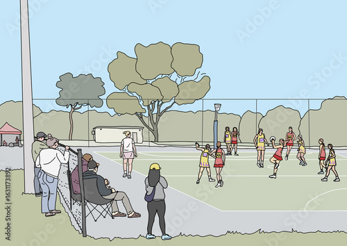 People sitting and standing on sidelines watching winter netball game