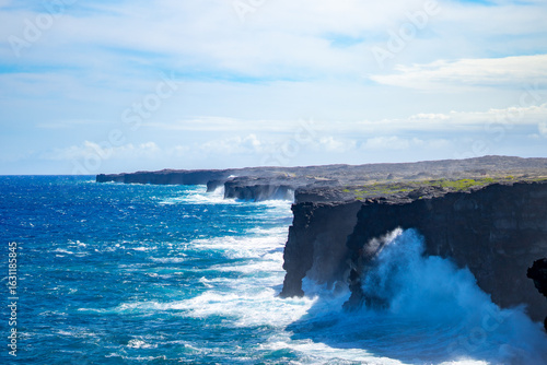 Powerful Ocean Waves Crash Against the Hōlei Sea Arch and Volcanic Lava Cliffs in Hawaii Volcanoes National Park, Big Island, Hawaii