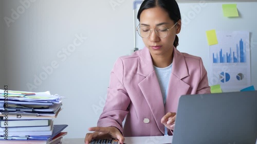 A young female office worker is stressed out by the assigned work. She has not completed her work according to the goals, which makes her irritable and in a bad mood.