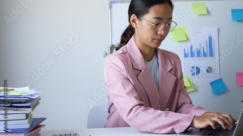 Young Asian woman feels numbness and severe pain in her wrist Caused by sitting and working for a long time Health care and office syndrome conceptใ	