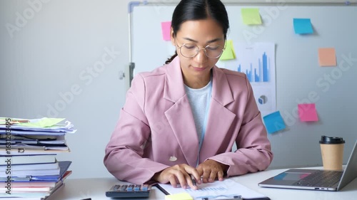 The young female employee is dedicated to her assigned work and successfully completes her goals. Working in the office.