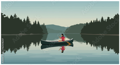 Woman paddling canoe on a lake, evergreen trees and mountain range in background