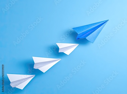 Free Download Blue paper airplane leading a flight of white ones on a light blue background - GFXLoad