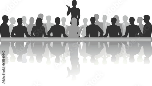 Silhouette of a presenter standing before a group of people at a long table with reflections below
