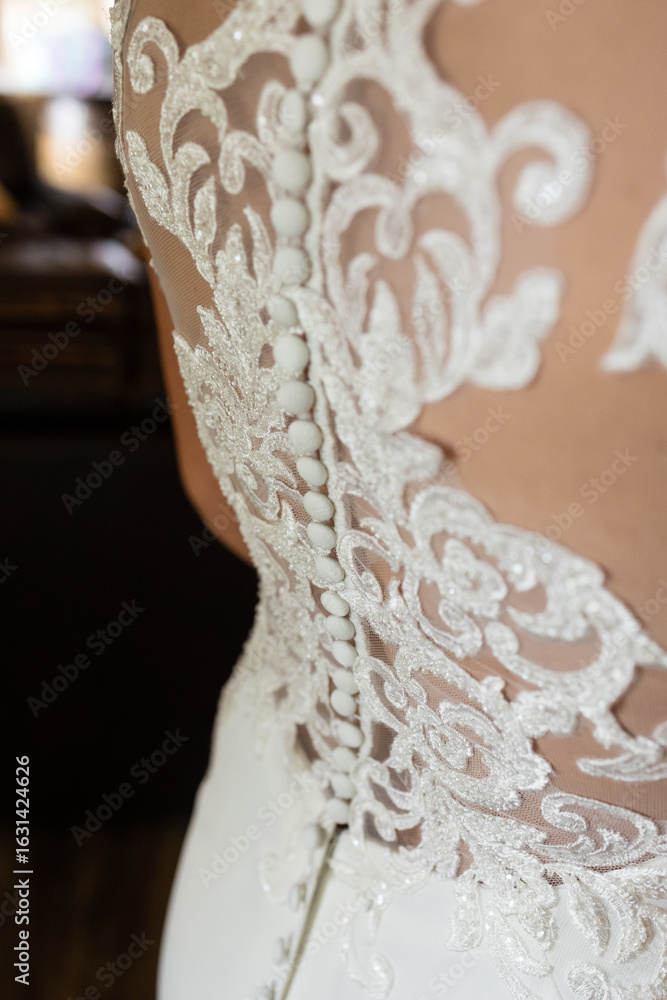Obraz premium Intricate lace and button detailing on back of wedding gown.