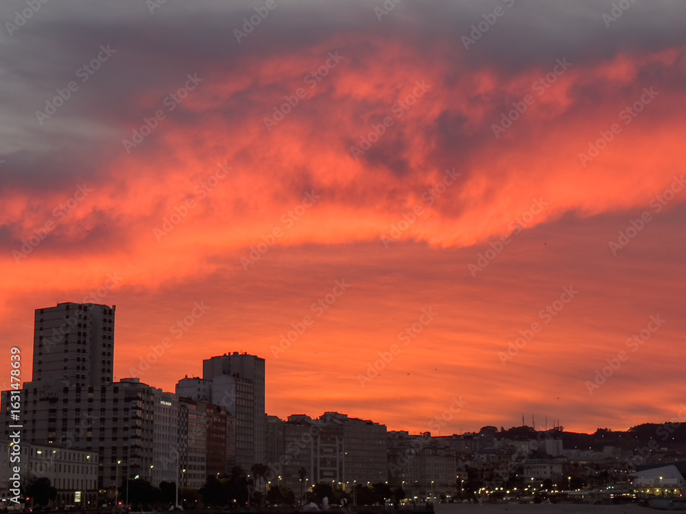 Fototapeta premium Vibrant red sunset over city skyline