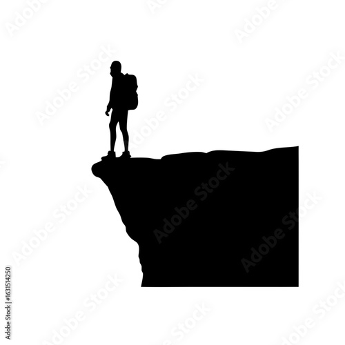 Hiker stands on cliff edge silhouette