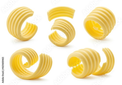 Photo of five swirls of yellow butter curls isolated on a white background, perfect for culinary and baking applications