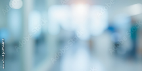 Abstract blur of hospital corridor or clinic interior, bright medical background with light flare for healthcare and science concepts