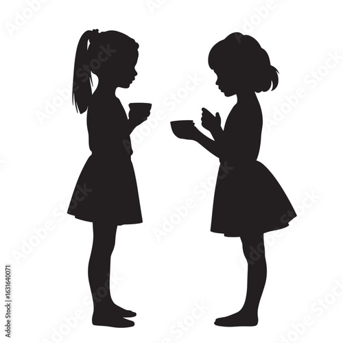 Two girls engaged in conversation while holding cups in silhouette  