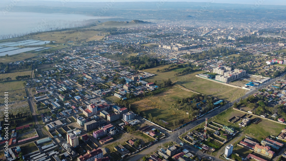 Fototapeta premium Aerial view showcasing Nakuru, Kenya, a city with diverse architecture and surrounding landscape on a clear day.