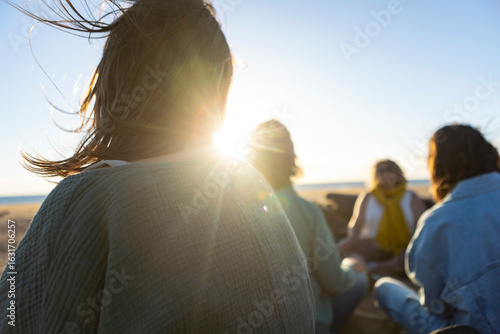 Tableau sur toile Women meditating together at the beach during a spiritual retreat