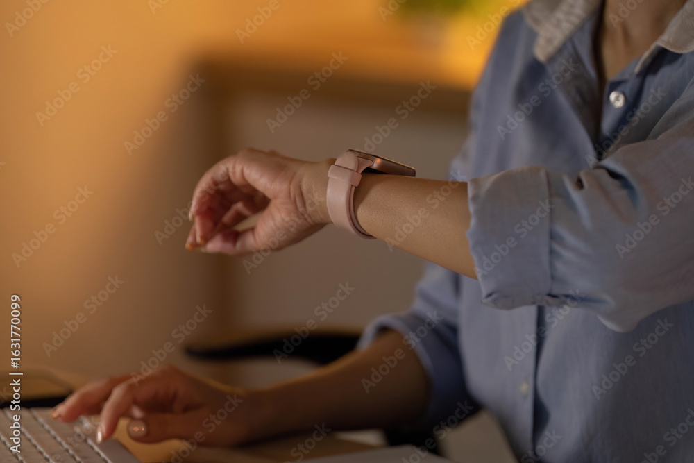 Fototapeta premium Smart Technology. Individual checking smartwatch while working.