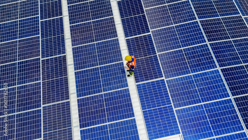 Solar panel technician working on photovoltaic installation in sunny weather