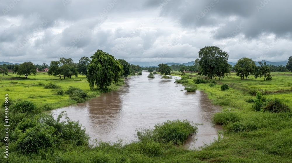 Fototapeta premium River Flowing Through Lush Green Landscape Under Cloudy Sky. Scenic View Of Nature'S Tranquility