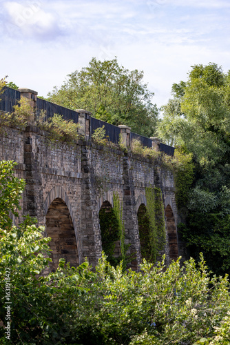 Stone bridge with ivy growing on it. Canal in Edinburgh