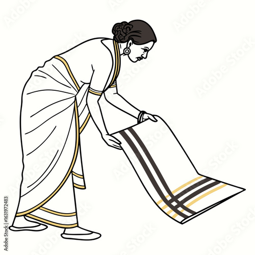 Indian woman in traditional saree carefully folding a dhoti with black and gold stripes