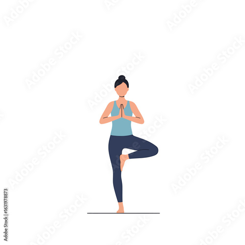 A young woman practices yoga, standing in the Tree Pose (Vrikshasana) with hands in prayer.