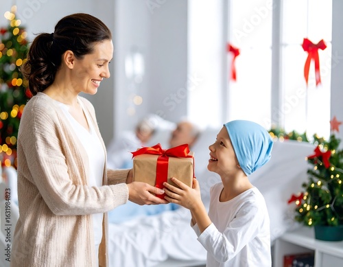 A woman gives a gift to a child in a hospital room decorated for Christmas