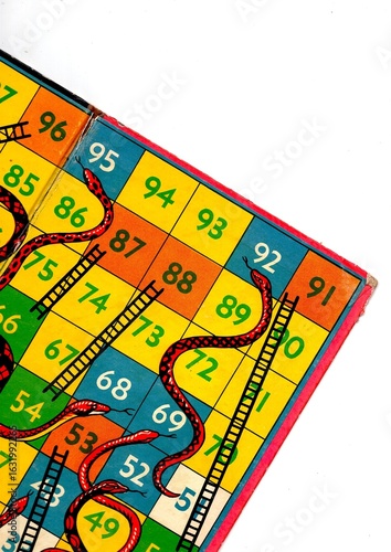 Detail from a vintage snakes and ladders game board.