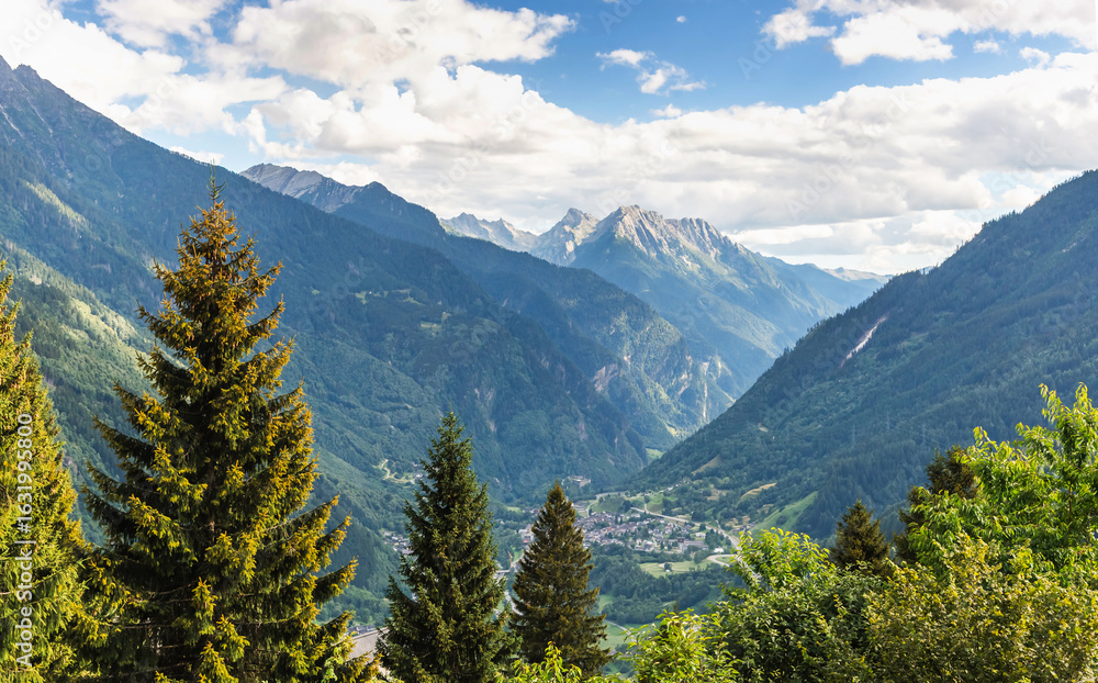 Fototapeta premium Alpine landscape. View of the Alpine mountains and village on a summer day