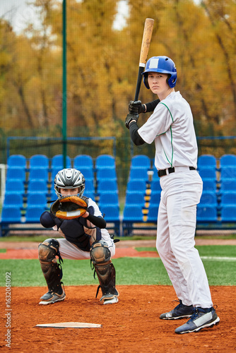 Photography Teenage boys engaging in an exciting baseball game on a sunny field