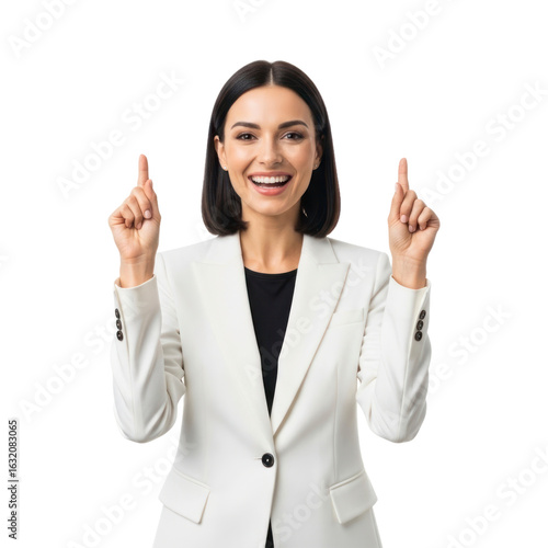 An excited and smiling businesswoman in a white suit points upwards with both index fingers.