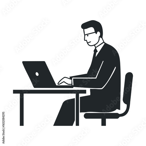 Silhouette of male worker at desk using laptop for office tasks