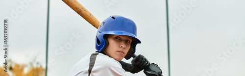 Photography Focused teenage boy ready to swing at baseball on a cloudy day in the field
