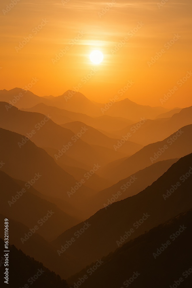Fototapeta premium Epic mountain silhouette landscape during dramatic golden hour sunset with layered atmospheric perspective