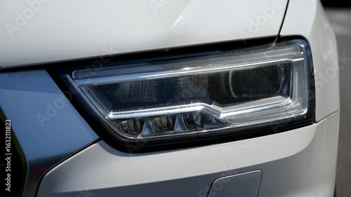 Seamless loop animation slideshow of car headlight brake light urban street background backdrop. Close up of a car. 