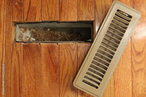 Принти на полотні A opened heating/cooling vent register on the floor in a home home