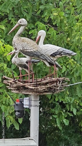 A group of birds on a metal post