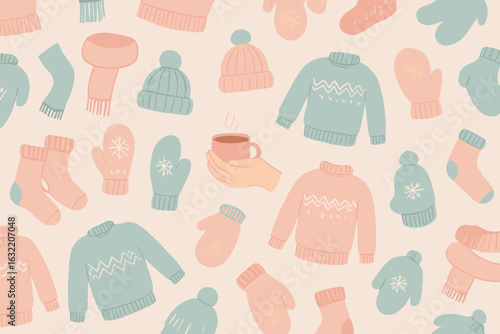 Cozy winter apparel and accessories scattered on a light background with warm drink in hand