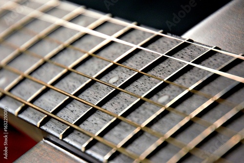 Fototapet Black guitar with strings from close up