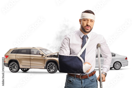 Injured man in a car accident with a damaged vehicle