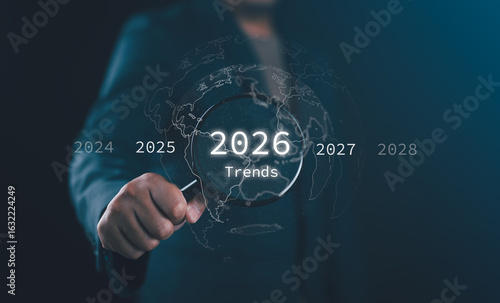 Future trend discovery concept in technology and business for 2026, a businessman explores upcoming global opportunities with magnifying glass and search for upcoming vacation destinations.