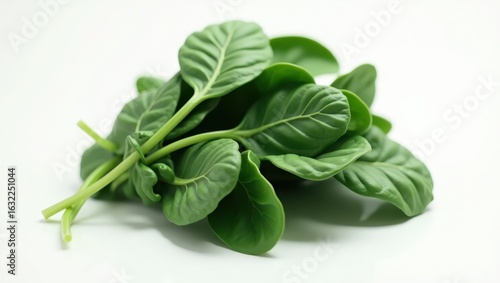 Fresh spinach leaves arranged on a white surface.