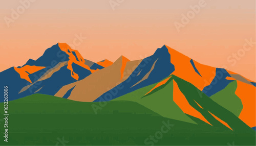 Mountain landscape with colorful peaks and green foreground at sunset  