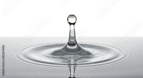 A water drops impact creates ripples on the clear surface