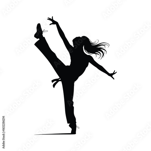 Silhouette of a dancer performing a high leg kick with flowing hair