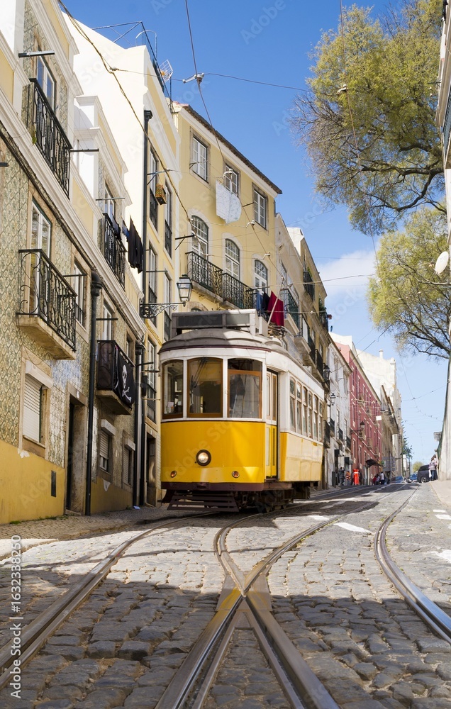 Fototapeta premium Yellow vintage tram in Bairro Alto neighborhood, Lisbon, Portugal