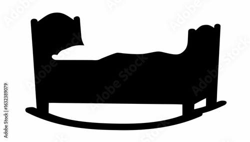 Silhouette of a rocking cradle with bedding and curved base design in a monochrome black and white image