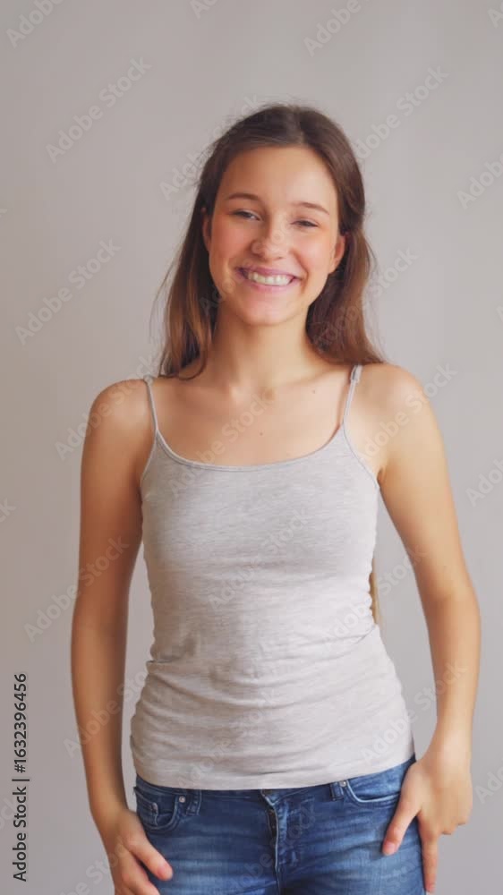 Beautiful young female laughing naturally with authentic joy. Vertical video perfect for happiness marketing and genuine social media campaigns. Beautiful young female laughing naturally with authentic joy. Vertical video perfect for happiness marketing and genuine social media campaigns.